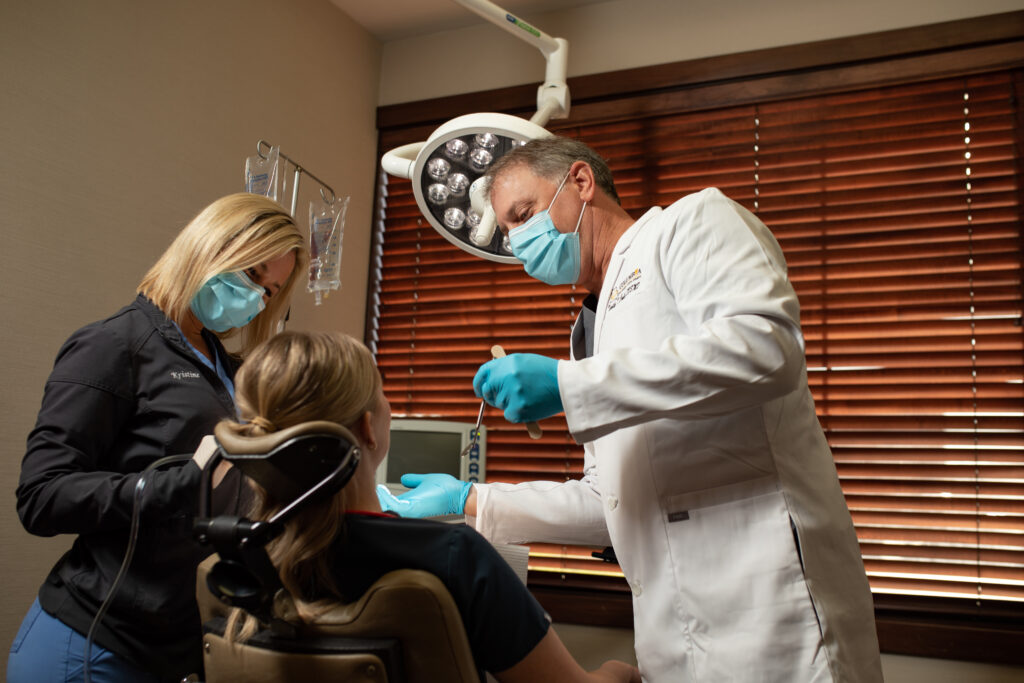 Oral Surgeon reviewing patients teeth