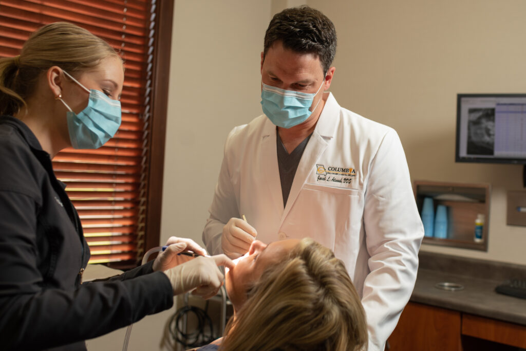 Columbia Oral Surgery Surgeon Checking on Patients Teeth